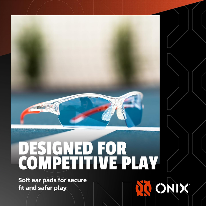 Blue tinted glasses with red arms and clear frame on a blurred background, featuring the ONIX brand on a blue tennis or pickleball court